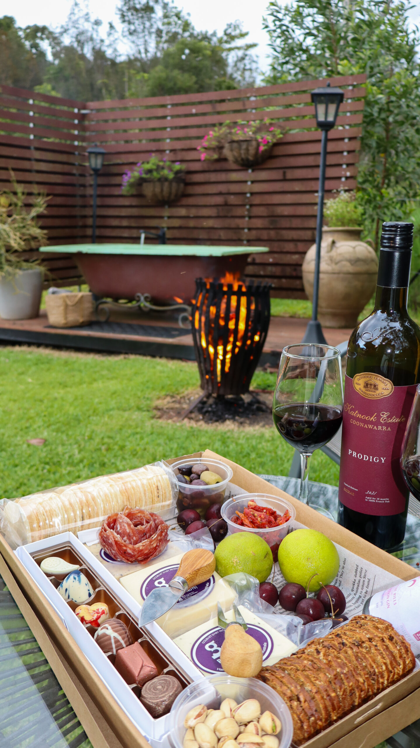 Outdoor area with an outdoor bath bottle of wine a cheese platter
